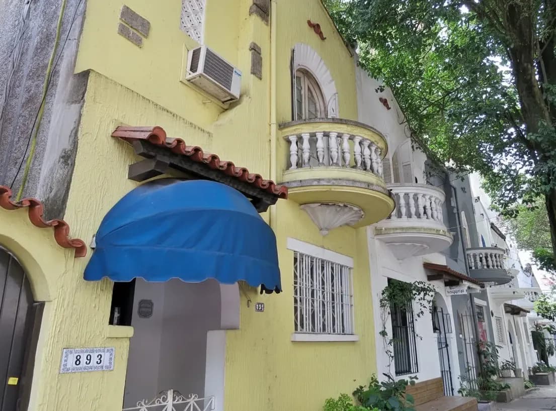Colorful townhouse with balconies and tree cover